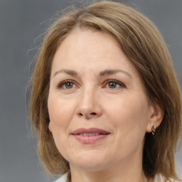 Joyful white adult female with medium  brown hair and brown eyes