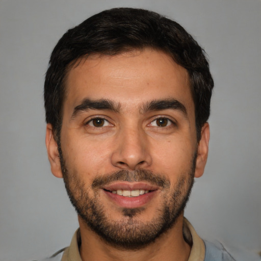 Joyful white young-adult male with short  black hair and brown eyes