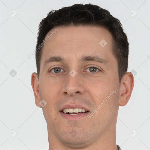 Joyful white young-adult male with short  brown hair and brown eyes