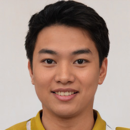 Joyful asian young-adult male with short  black hair and brown eyes