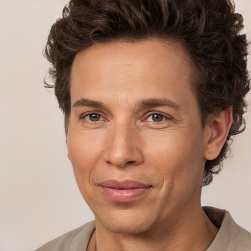 Joyful white adult male with medium  brown hair and brown eyes