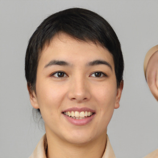 Joyful white young-adult female with medium  black hair and brown eyes