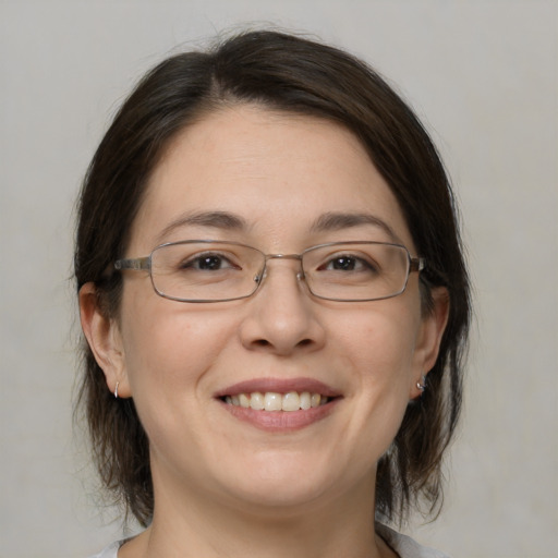 Joyful white adult female with medium  brown hair and brown eyes