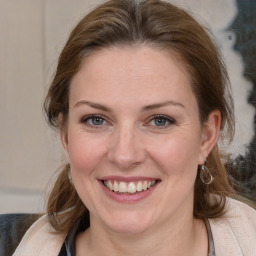 Joyful white adult female with medium  brown hair and brown eyes