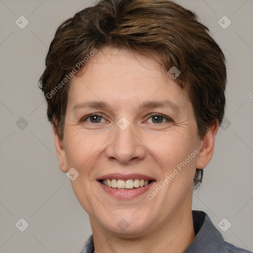 Joyful white adult female with short  brown hair and grey eyes