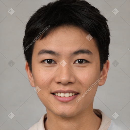 Joyful asian young-adult male with short  brown hair and brown eyes