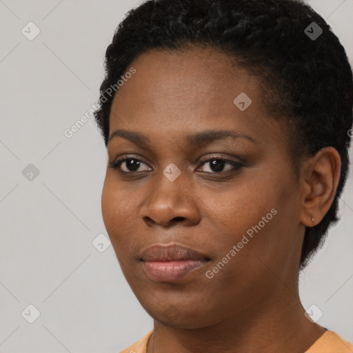 Joyful black young-adult female with short  black hair and brown eyes