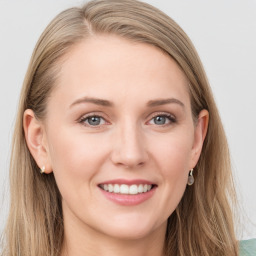 Joyful white young-adult female with long  brown hair and blue eyes