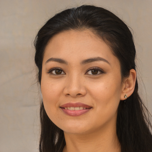 Joyful asian young-adult female with long  brown hair and brown eyes