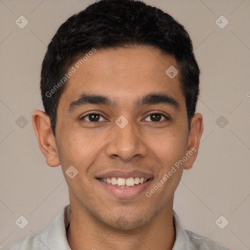 Joyful latino young-adult male with short  black hair and brown eyes