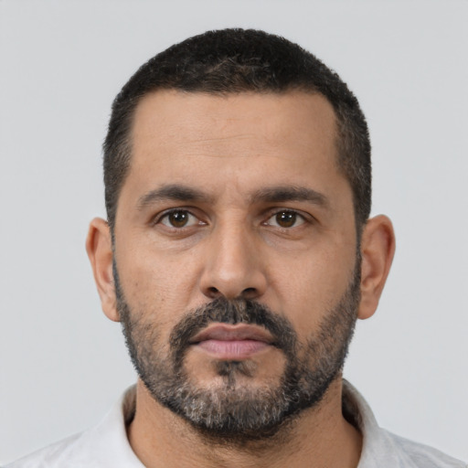 Neutral latino adult male with short  black hair and brown eyes