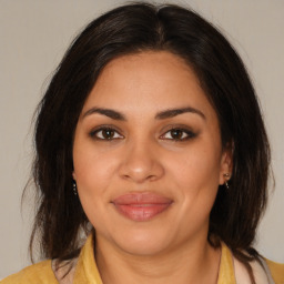 Joyful latino young-adult female with medium  brown hair and brown eyes