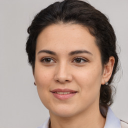 Joyful latino young-adult female with medium  brown hair and brown eyes