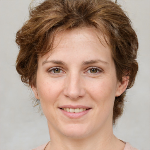 Joyful white young-adult female with medium  brown hair and green eyes