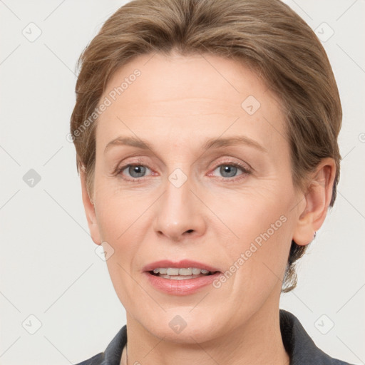 Joyful white adult female with short  brown hair and grey eyes