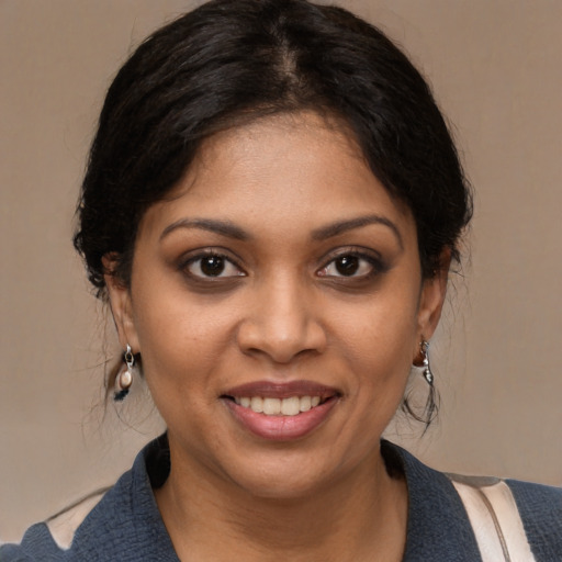 Joyful black young-adult female with medium  black hair and brown eyes