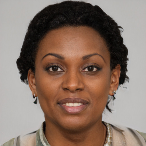 Joyful black young-adult female with short  brown hair and brown eyes