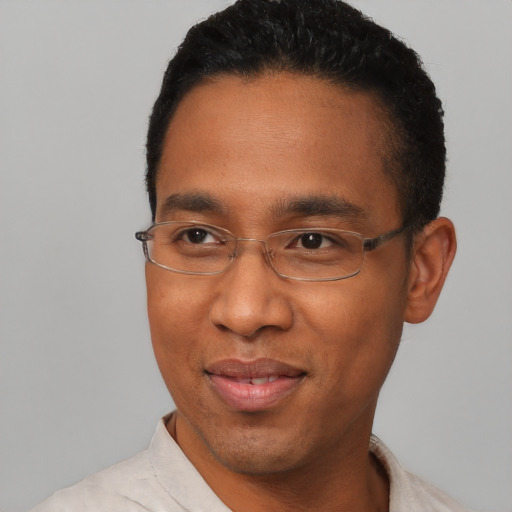 Joyful black young-adult male with short  black hair and brown eyes