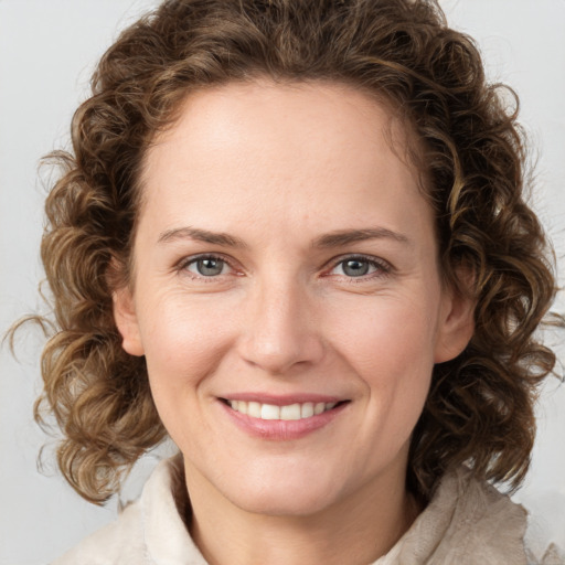 Joyful white young-adult female with medium  brown hair and green eyes