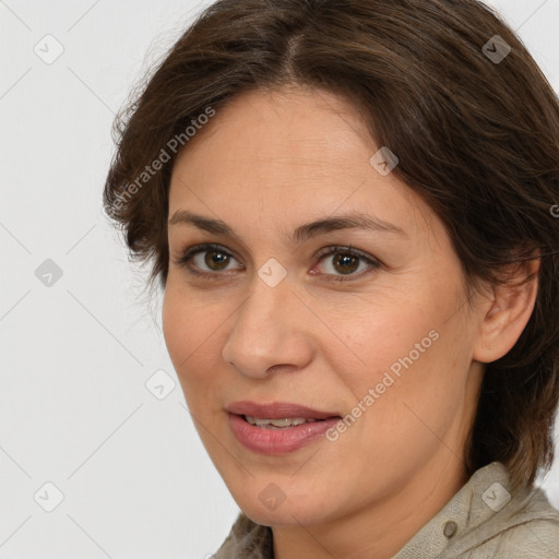 Joyful white adult female with medium  brown hair and brown eyes