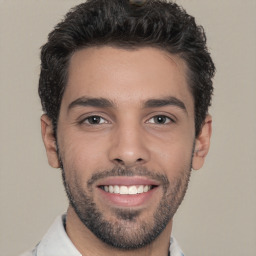 Joyful white young-adult male with short  black hair and brown eyes