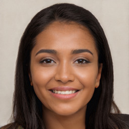 Joyful latino young-adult female with long  brown hair and brown eyes