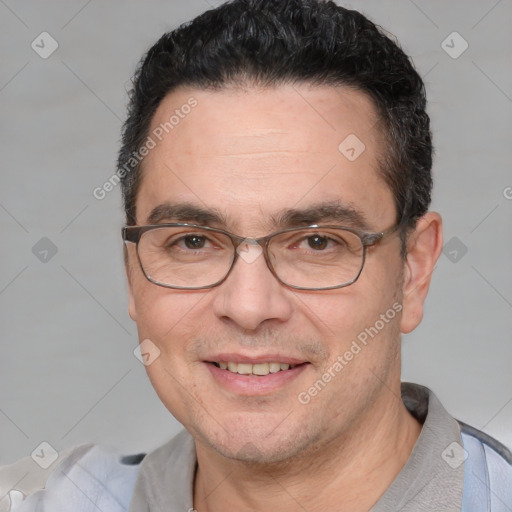 Joyful white adult male with short  black hair and brown eyes