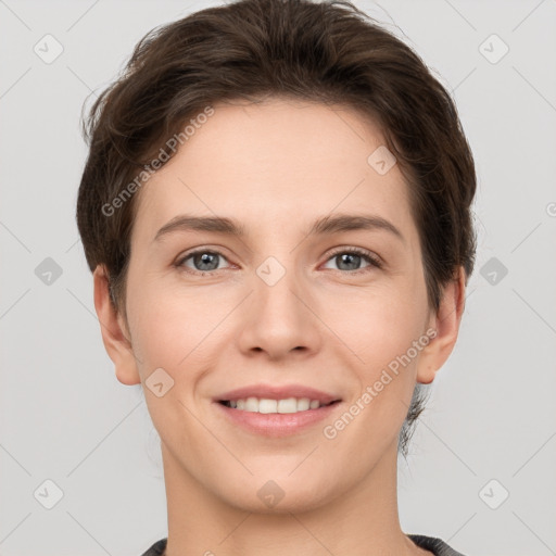 Joyful white young-adult female with short  brown hair and grey eyes