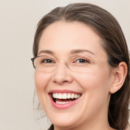 Joyful white adult female with medium  brown hair and brown eyes