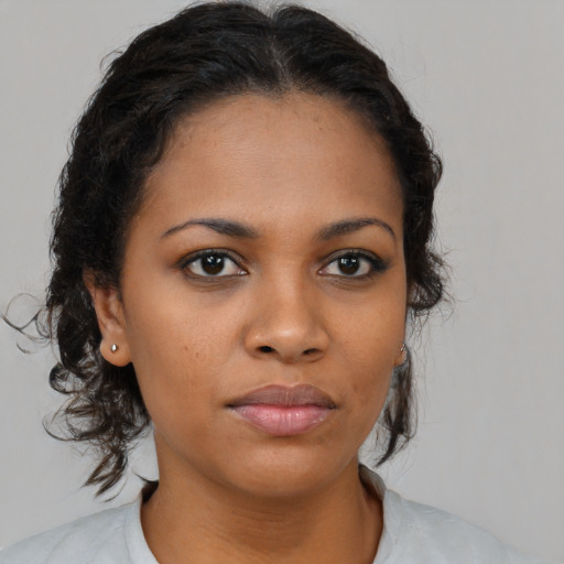 Neutral black young-adult female with medium  brown hair and brown eyes