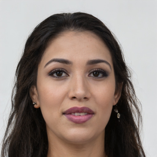 Joyful latino young-adult female with long  brown hair and brown eyes