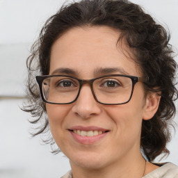 Joyful white adult female with medium  brown hair and brown eyes