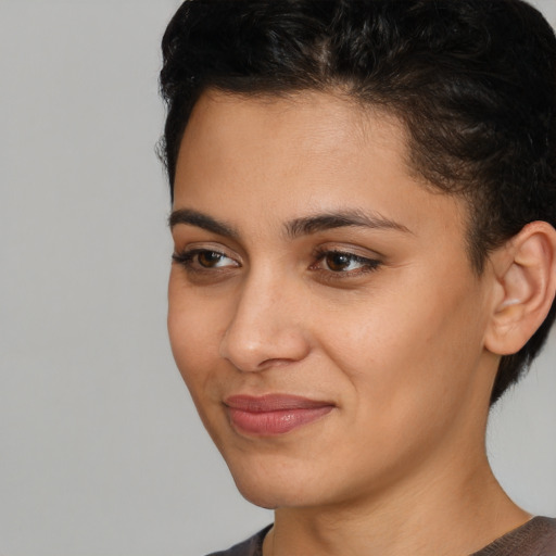 Joyful latino young-adult female with short  brown hair and brown eyes