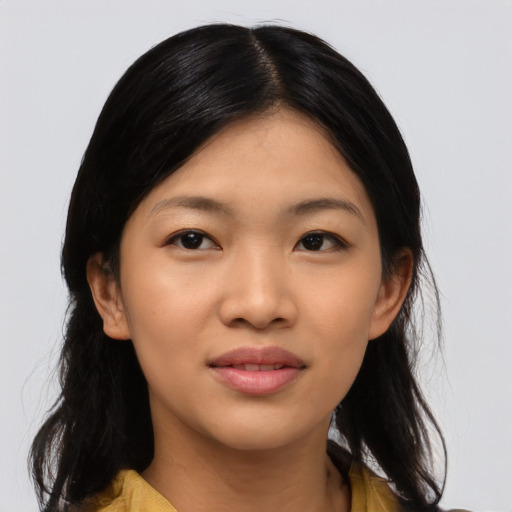 Joyful asian young-adult female with long  black hair and brown eyes