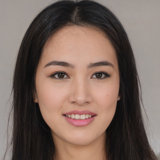 Joyful white young-adult female with long  brown hair and brown eyes