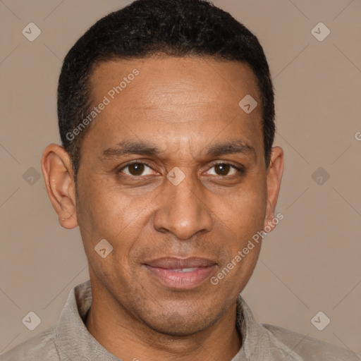 Joyful latino adult male with short  brown hair and brown eyes