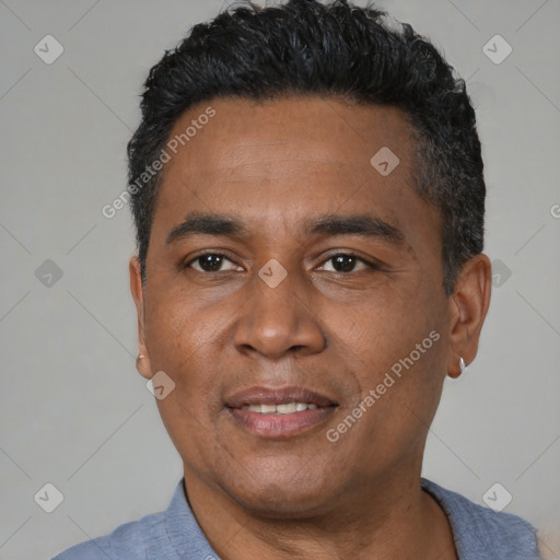 Joyful latino adult male with short  black hair and brown eyes