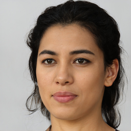 Joyful latino young-adult female with medium  black hair and brown eyes