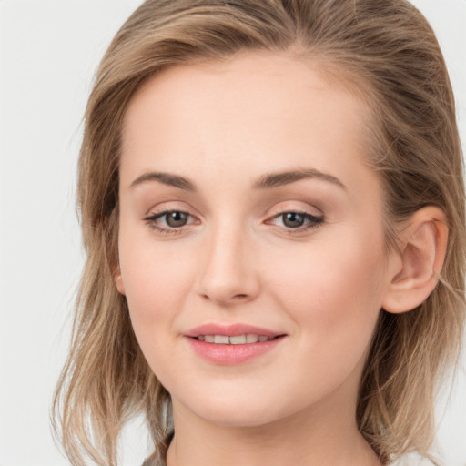 Joyful white young-adult female with long  brown hair and grey eyes