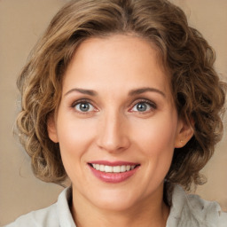 Joyful white young-adult female with medium  brown hair and green eyes