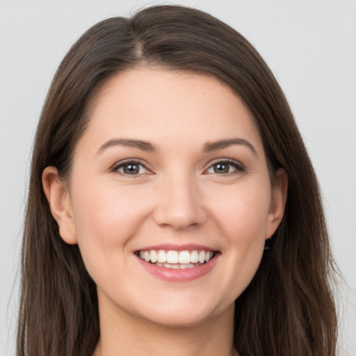 Joyful white young-adult female with long  brown hair and grey eyes