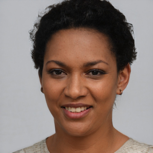 Joyful latino young-adult female with short  black hair and brown eyes