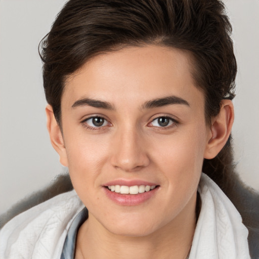 Joyful white young-adult female with short  brown hair and brown eyes