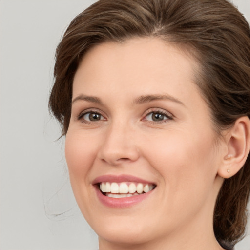 Joyful white young-adult female with medium  brown hair and brown eyes