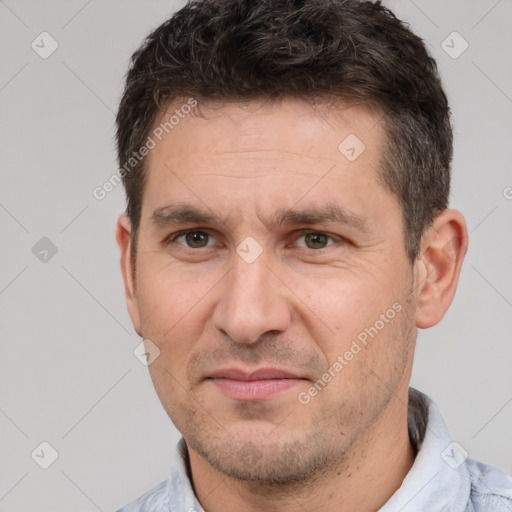 Joyful white adult male with short  brown hair and brown eyes