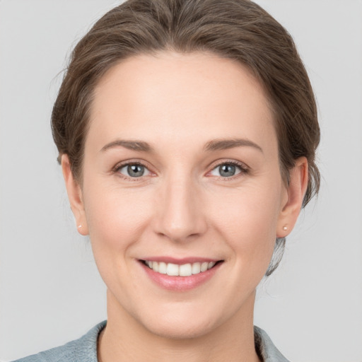 Joyful white young-adult female with short  brown hair and grey eyes