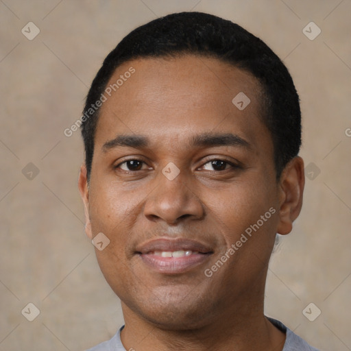 Joyful latino young-adult male with short  black hair and brown eyes