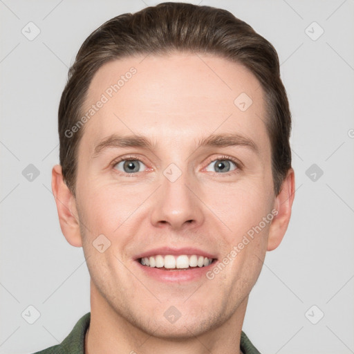 Joyful white young-adult male with short  brown hair and grey eyes