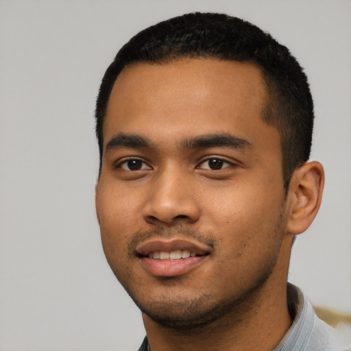 Joyful black young-adult male with short  black hair and brown eyes