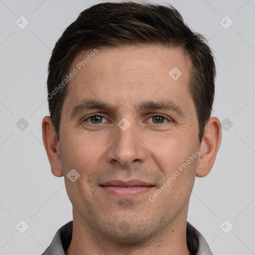 Joyful white adult male with short  brown hair and brown eyes